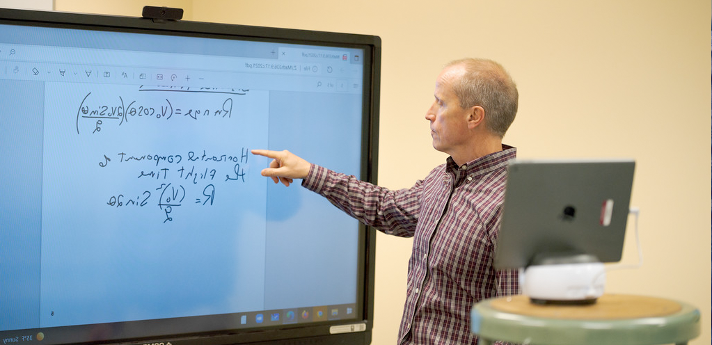 Dr. Vogl recording a video demonstration in front of a digital whiteboard.